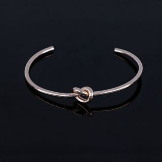Stainless steel rose gold plated bangle with a knot - 