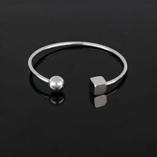 Stainless steel bangle with geometric shapes - 