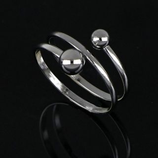 Stainless steel twisted ring with small and big ball - 
