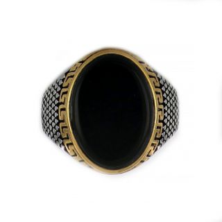 Ring made of stainless steel with gold plated meander embossed design and black stone. - 