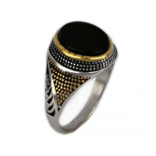 Ring made of stainless steel with gold plated embossed design and black stone.