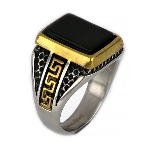 Ring made of stainless steel with embossed gold plated meander to the sides and black stone.