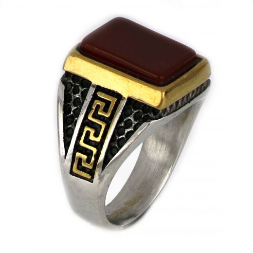 Ring made of stainless steel with embossed gold plated meander to the sides and carnelian stone.